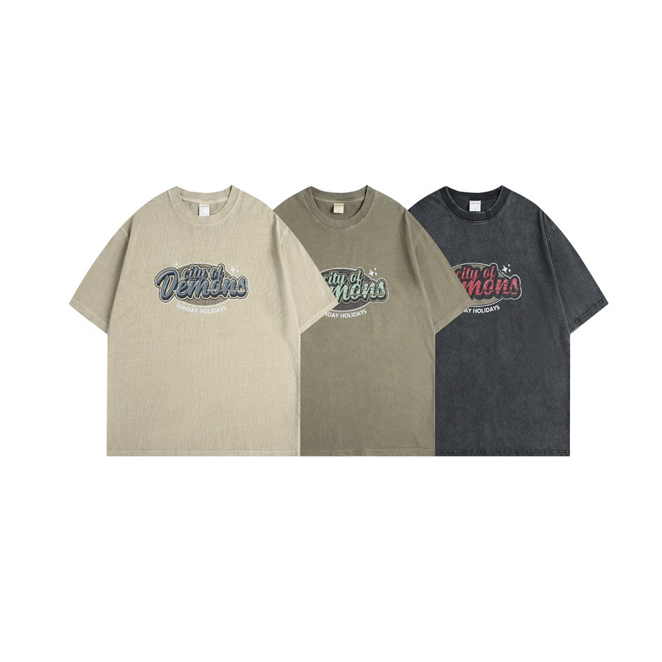Three short-sleeve graphic T-shirts shown from the front in beige, olive, and charcoal colorways.