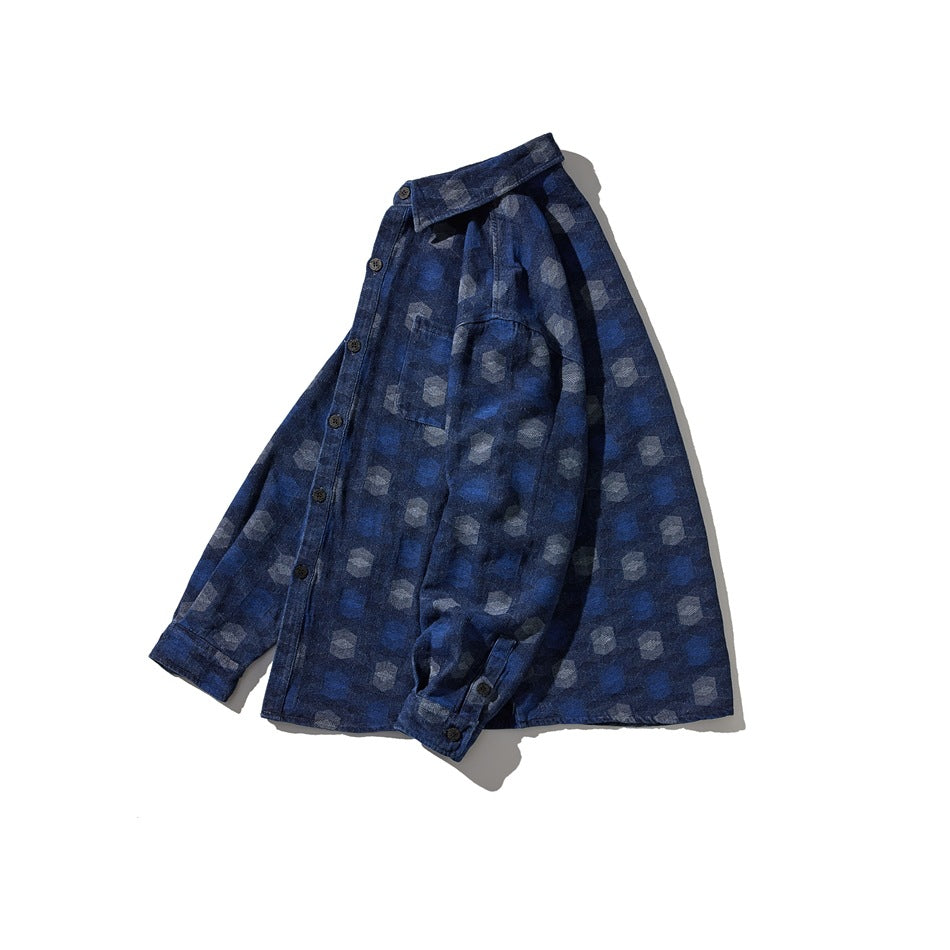 Dark blue button-front shirt laid flat, with a collar, long sleeves, chest pocket, and repeating pale geometric pattern.