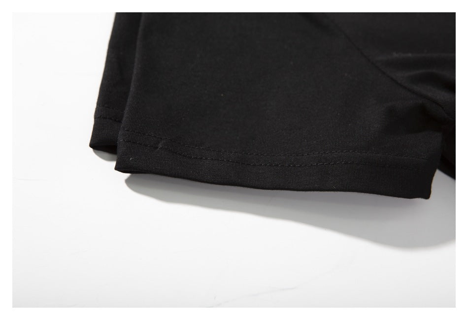 Close-up of a black shirt sleeve hem with visible stitching.