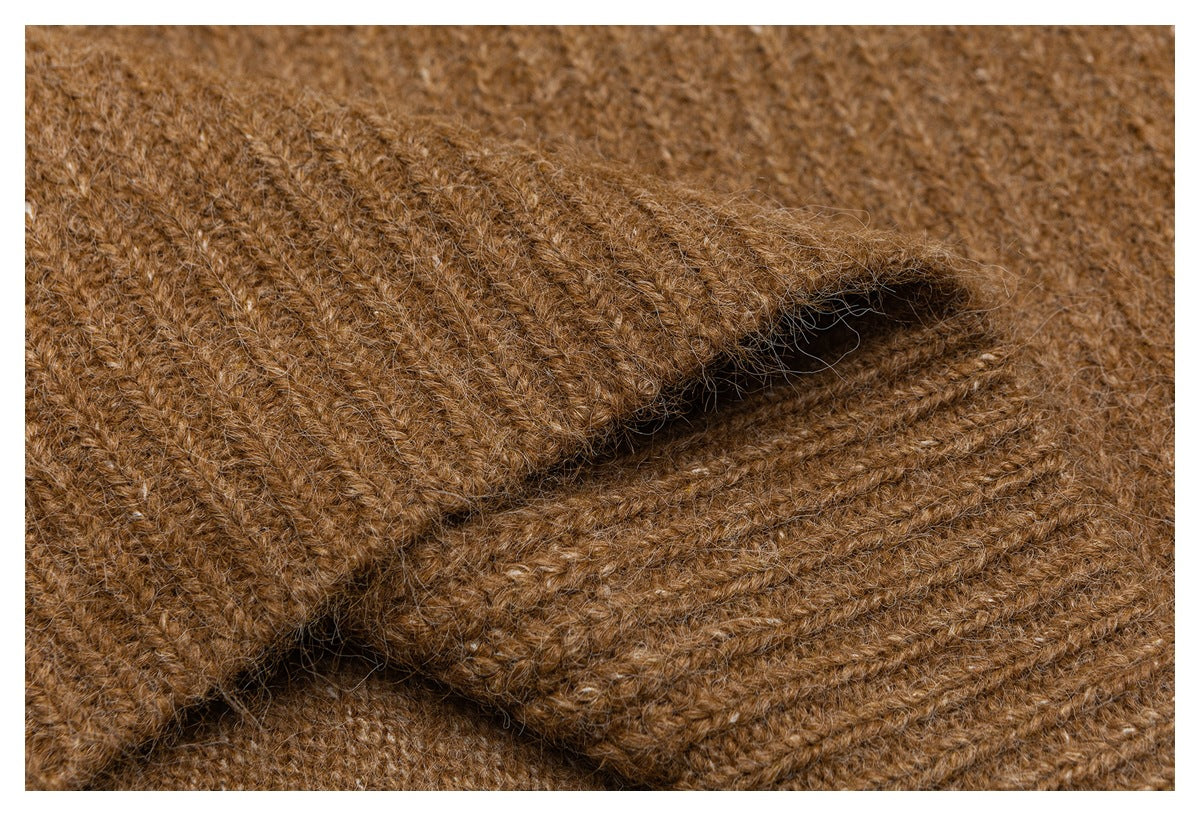 Close-up of a folded brown knit edge showing its fuzzy texture and stitching.