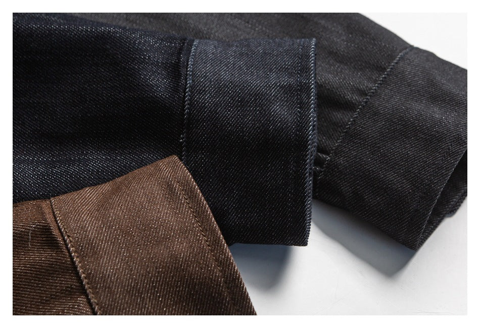 Close-up of black and brown shirt fabric folded to show the cuffs and fine diagonal texture.