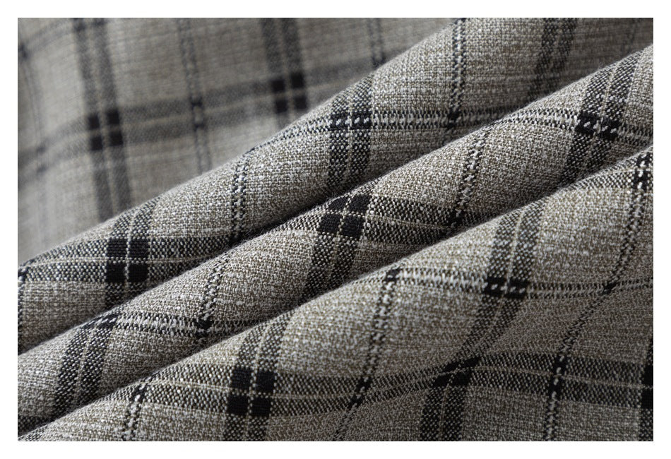 Macro view of the woven texture and dark plaid pattern on gray-beige fabric.