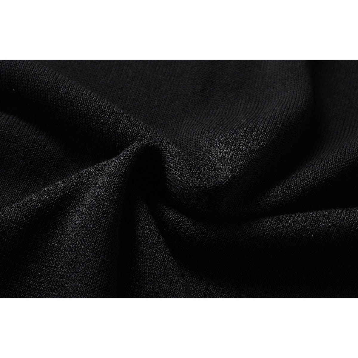 Close-up showing the textured black knit fabric draped into soft folds.