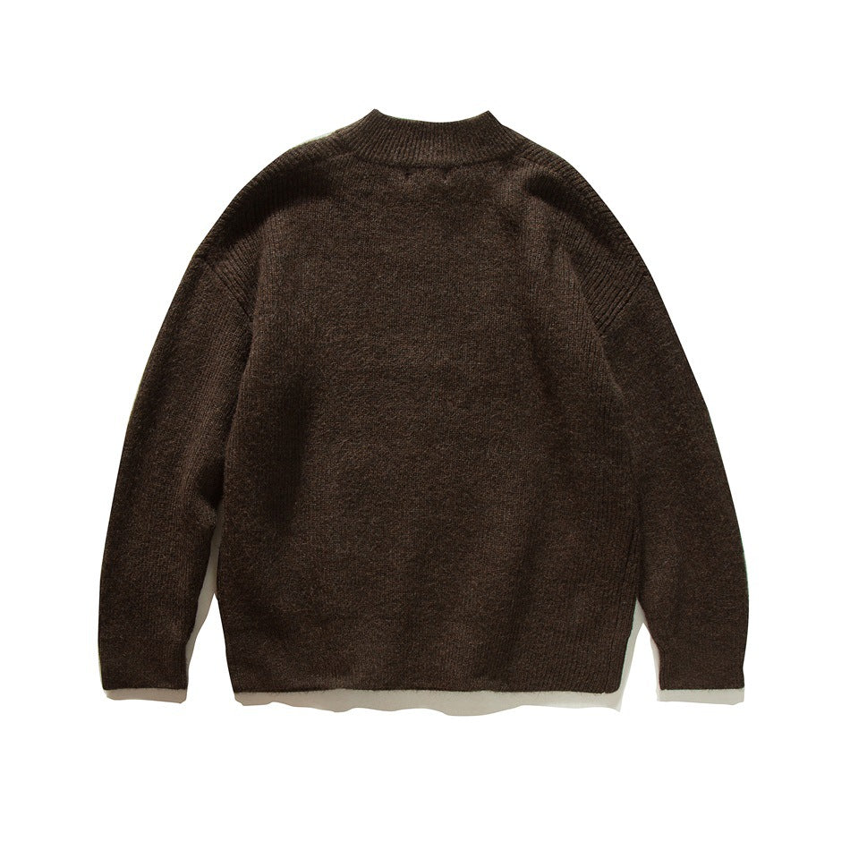 Back view of a dark brown knit sweater with a ribbed stand collar, cuffs, and hem.
