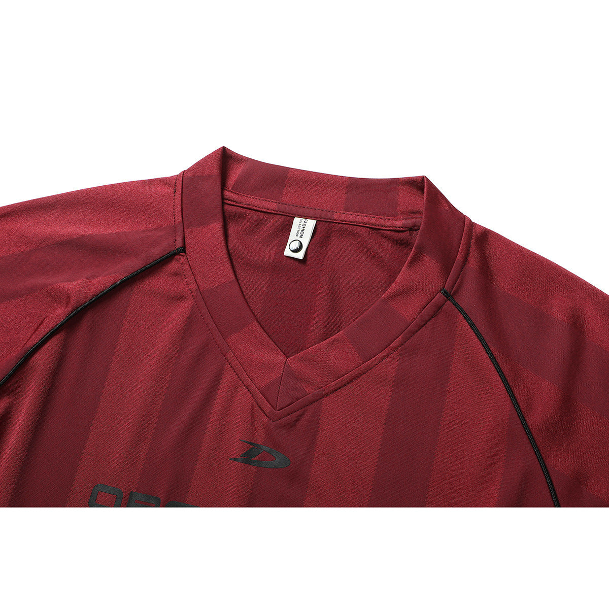 Close-up of a red V-neck shirt with black piping, a small chest logo, and a visible neck label.