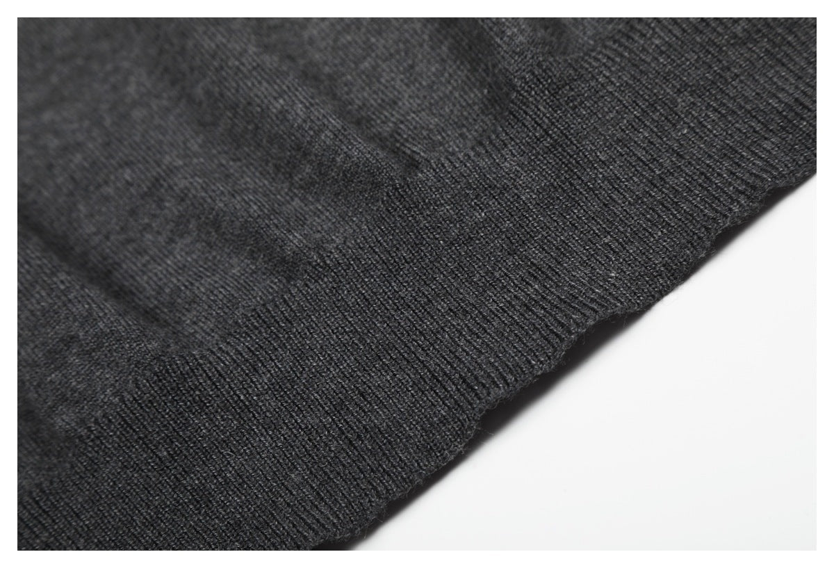 Close-up of the charcoal knit top's ribbed hem and knit texture.