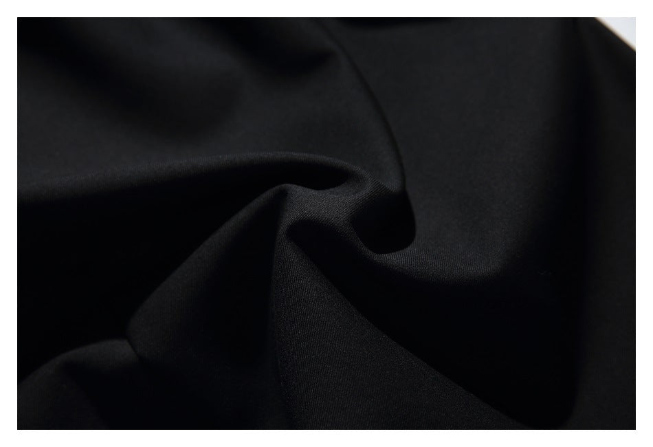 Close-up of black fabric gathered into soft folds.
