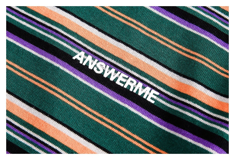 Close-up of the dark green knit fabric with multicolor stripes and white ANSWERME lettering.