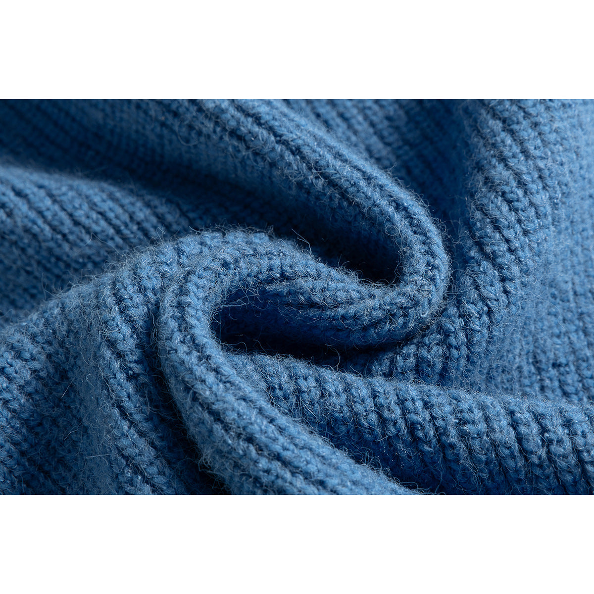 Close-up of blue knit fabric showing a thick ribbed seam and edge.
