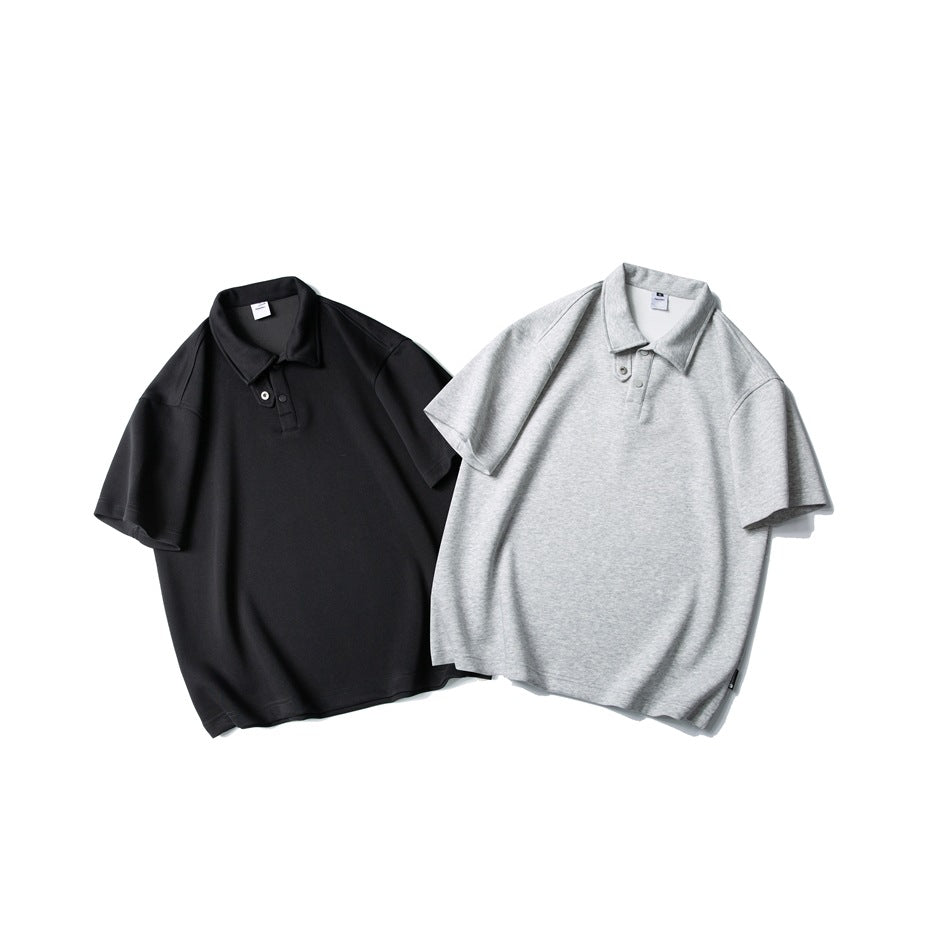 Two short-sleeve polo shirts shown from the front: one black and one light heather gray.