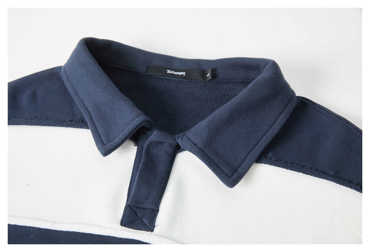 Close-up of a navy-and-white striped rugby shirt's collar and short placket.
