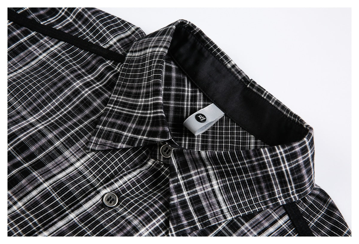 Close-up of a black-and-white plaid shirt collar, buttons, black trim, and an XL neck label.