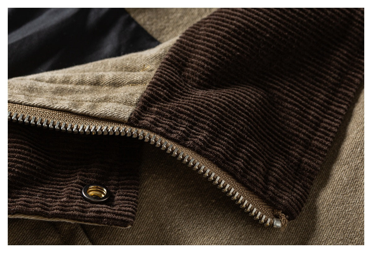 Close-up of a jacket's dark brown ribbed collar, metal zipper, and matching snap detail.