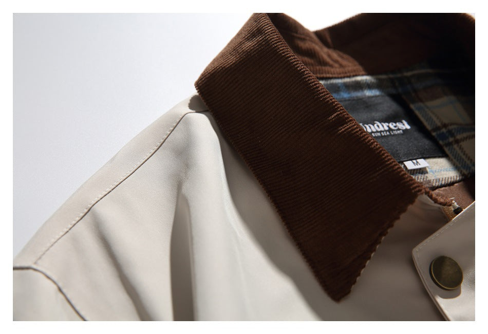 Close-up of the brown collar, shoulder seam and plaid lining with a garment label.