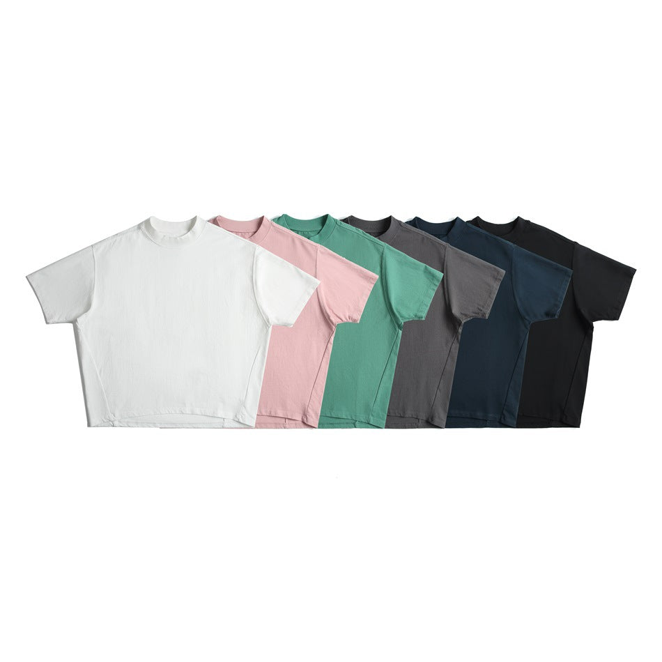 Six plain short-sleeve crew-neck T-shirts arranged together in white, pink, mint, gray, navy, and black.