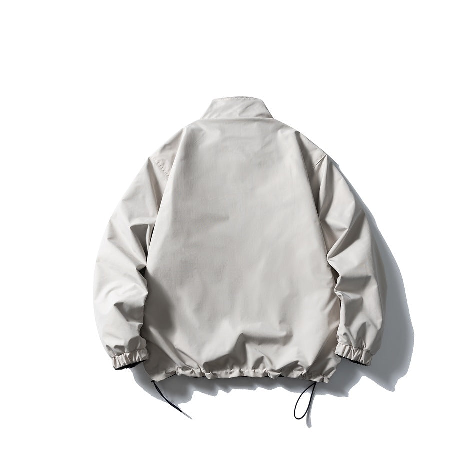 Back view of a light gray jacket with a stand collar, elastic cuffs, and adjustable cords at the hem.