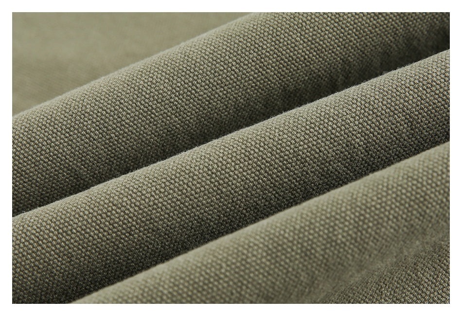 Macro view of the olive-khaki garment's textured woven fabric.