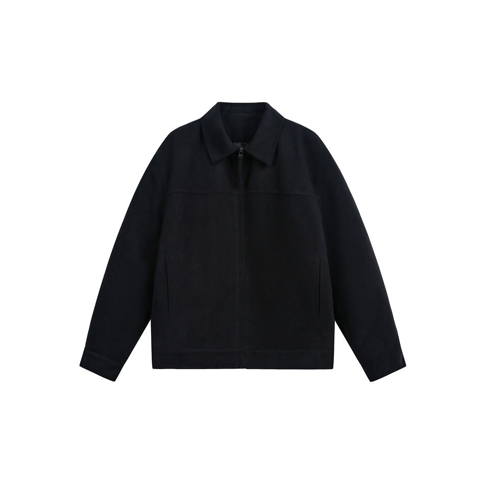 Black zip-front collared jacket laid flat, front view, with yoke seam, side pockets and plain banded hem