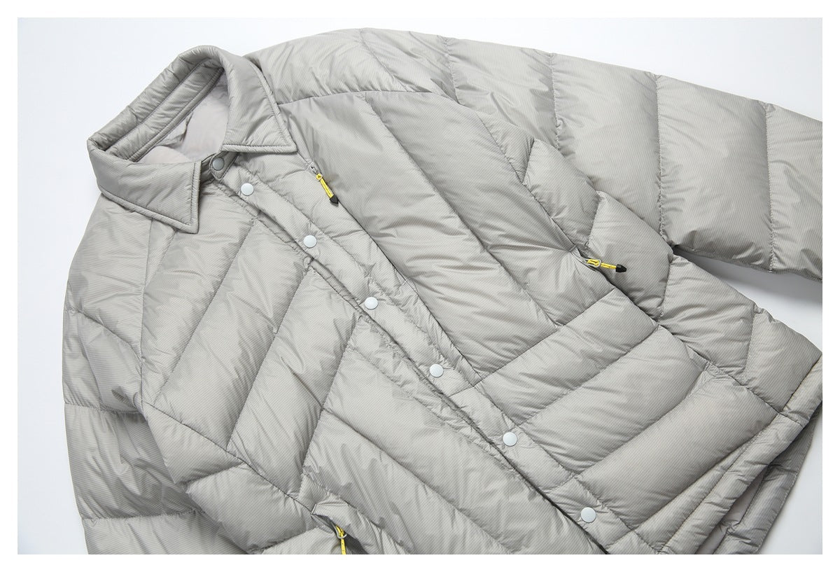 Angled view of a light gray pinstriped puffer jacket with snap buttons and yellow zipper pulls, laid flat.