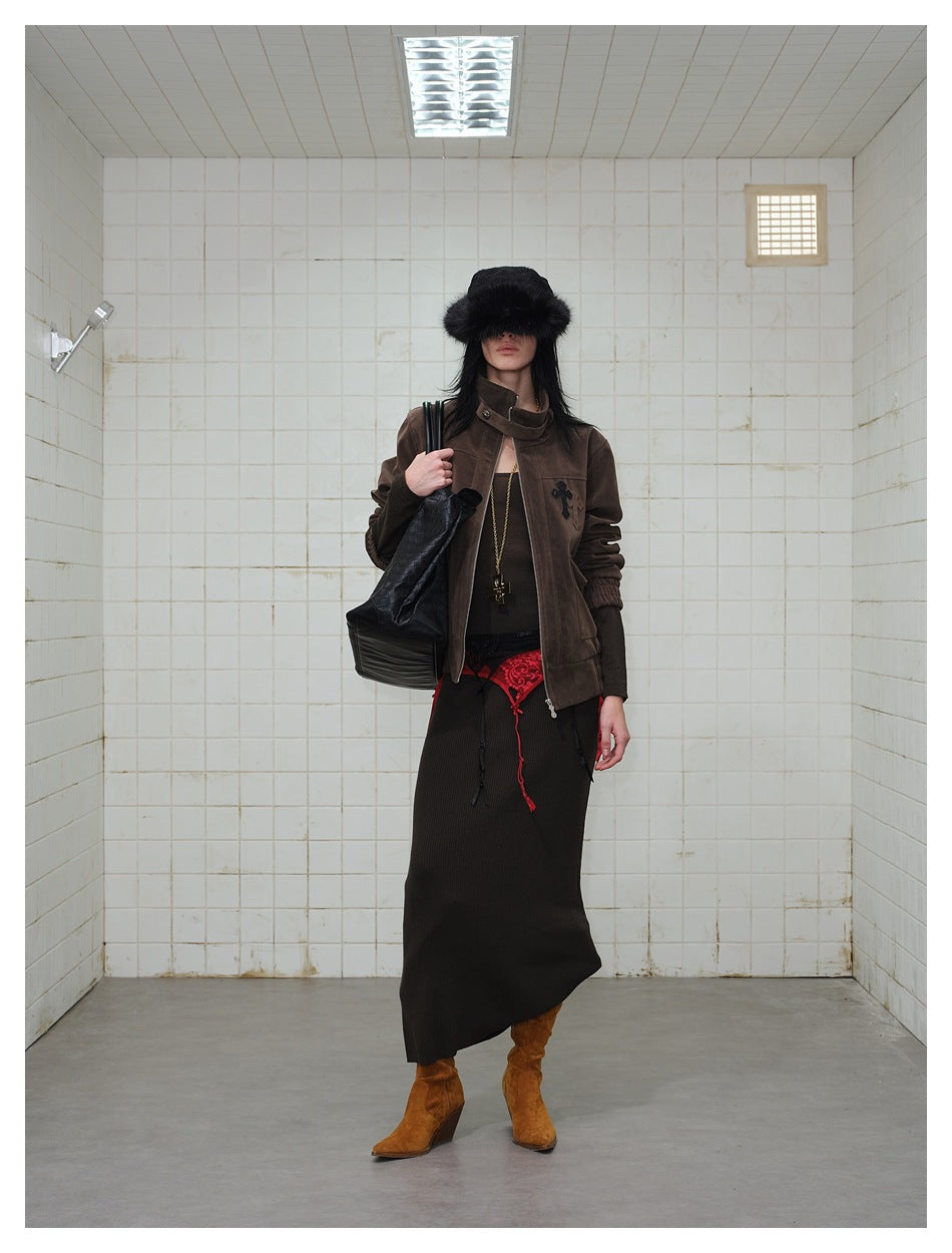 Front view of a model wearing a dark brown jacket over a long black skirt with red lace detail.