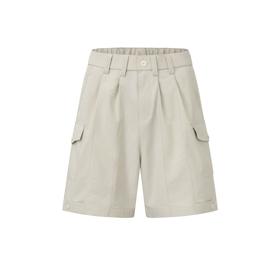 Beige pleated cargo shorts with side flap pockets, belt loops, button closure and snap tabs at the hems, front view