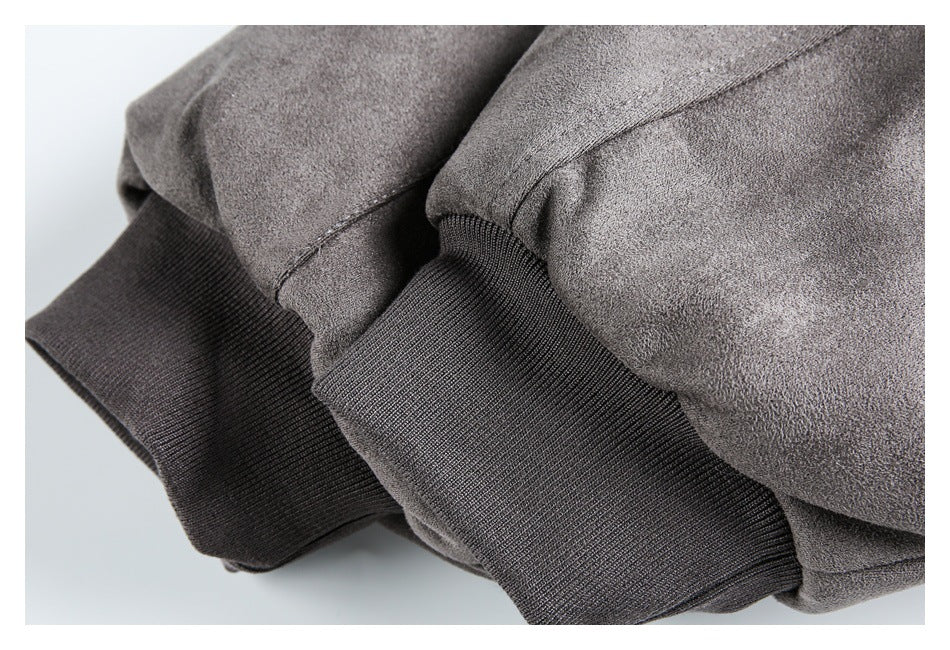 Close-up of a gray coat sleeve with a wide dark ribbed cuff.