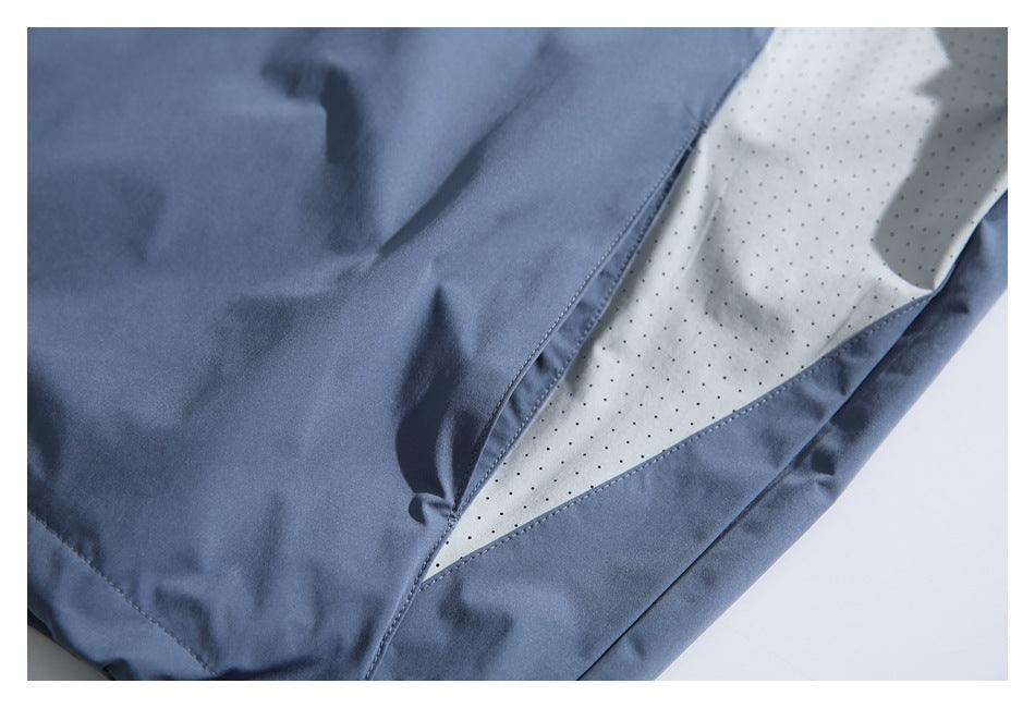 Blue garment detail showing a white perforated inner panel between fabric seams.