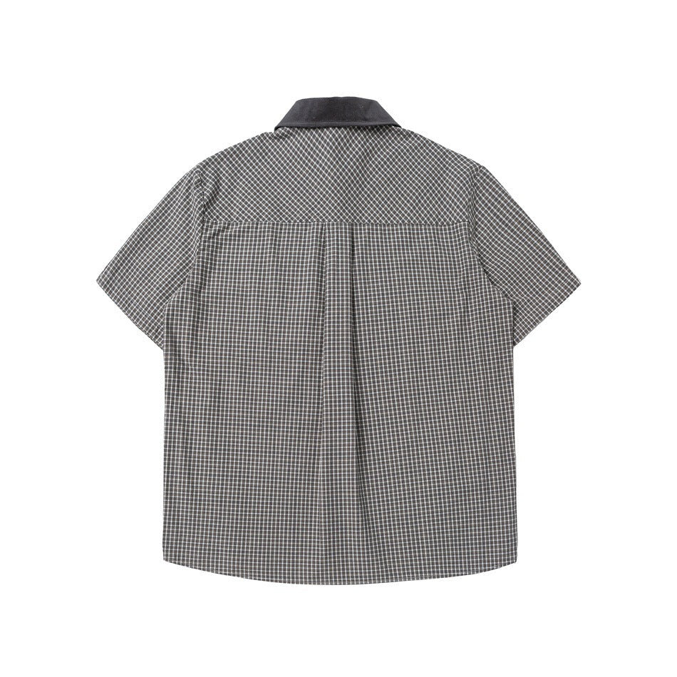 Back view of a gray-and-white checked short-sleeve shirt with a dark collar and center pleat.