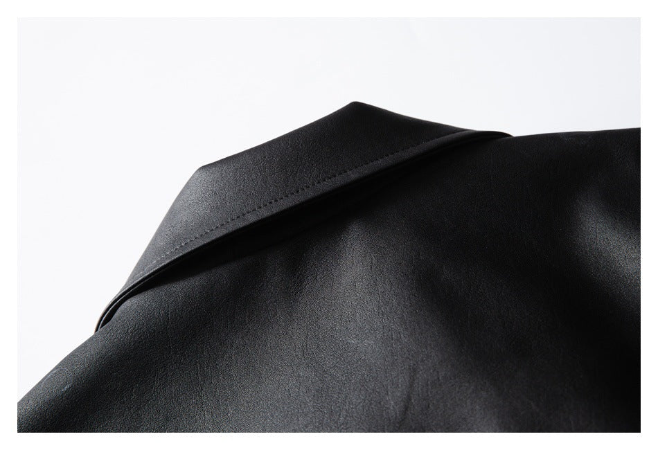 Close-up of the black jacket's wide pointed collar and smooth surface.