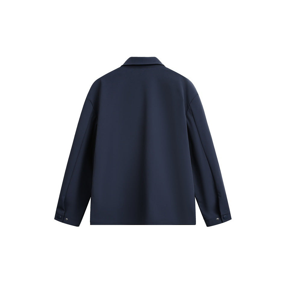 Back view of a dark navy jacket with a folded collar and long sleeves with snap-tab cuffs.
