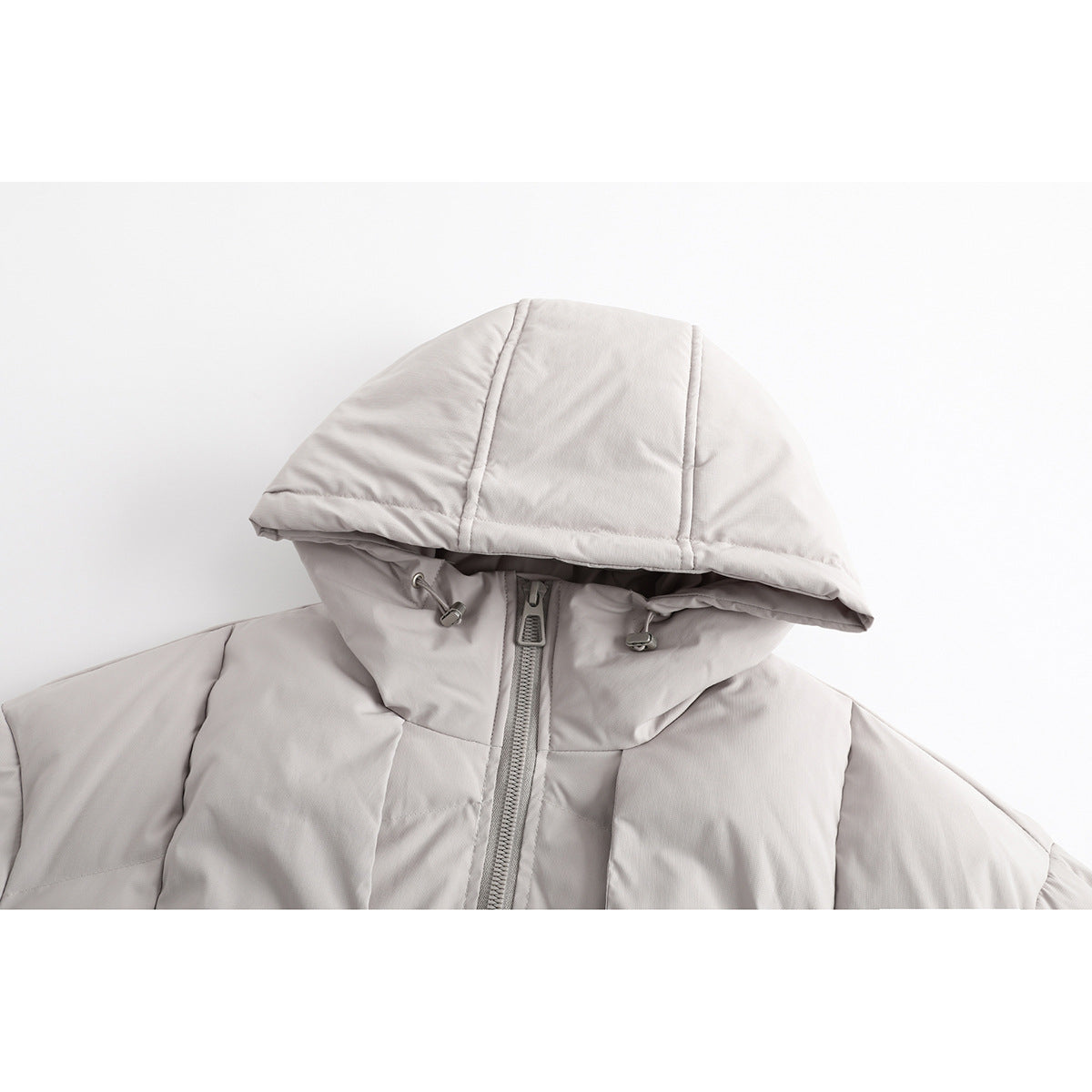 Close-up of a light gray hood, high collar, drawcord toggles, and front zipper on a padded jacket.