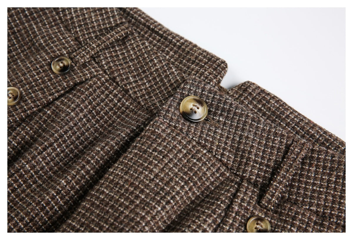 Close-up of brown and cream small-check fabric with several tan buttons and stitched seams.