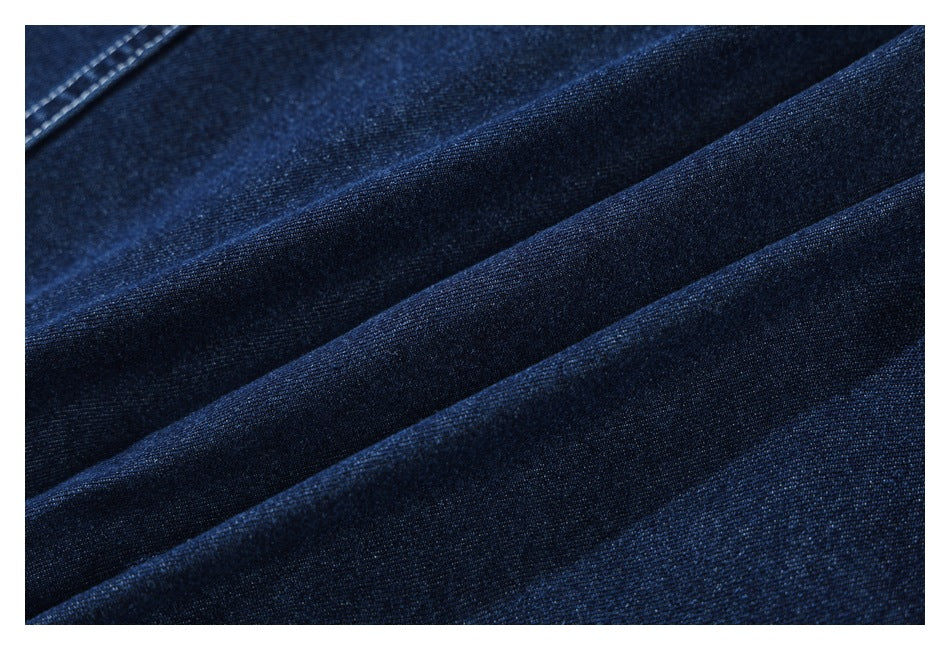 Close-up showing the dark indigo denim fabric draped into folds.