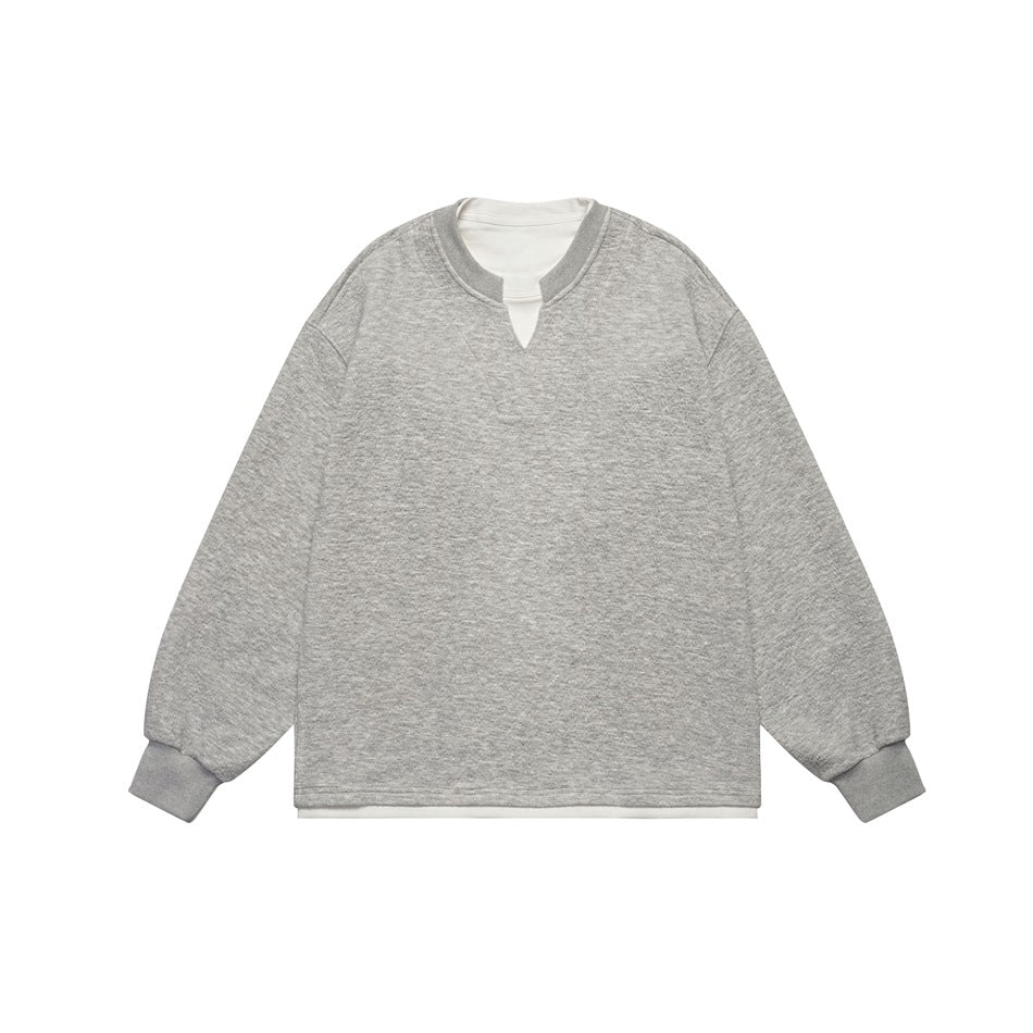 Light heather gray pullover sweatshirt with notched neckline, ribbed cuffs and white layered under-hem, flat lay