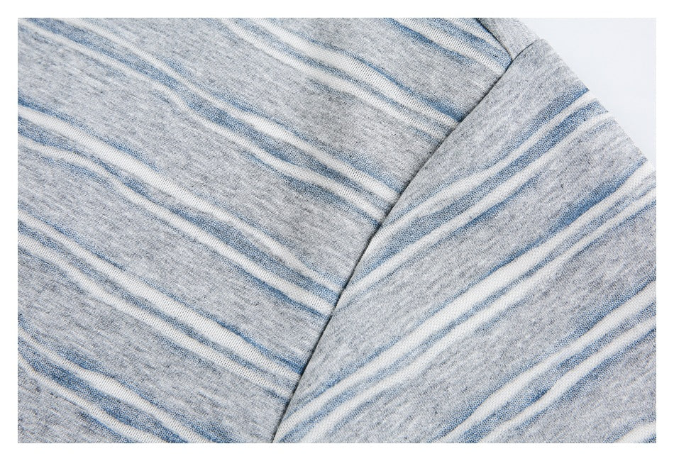 Close-up of the T-shirt's gray, white, and blue striped fabric and sleeve seam.