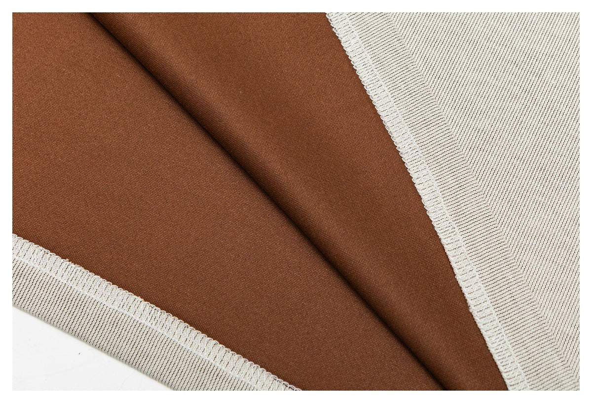 Close-up of brown fabric with cream ribbed knit edging and visible overlock stitching.