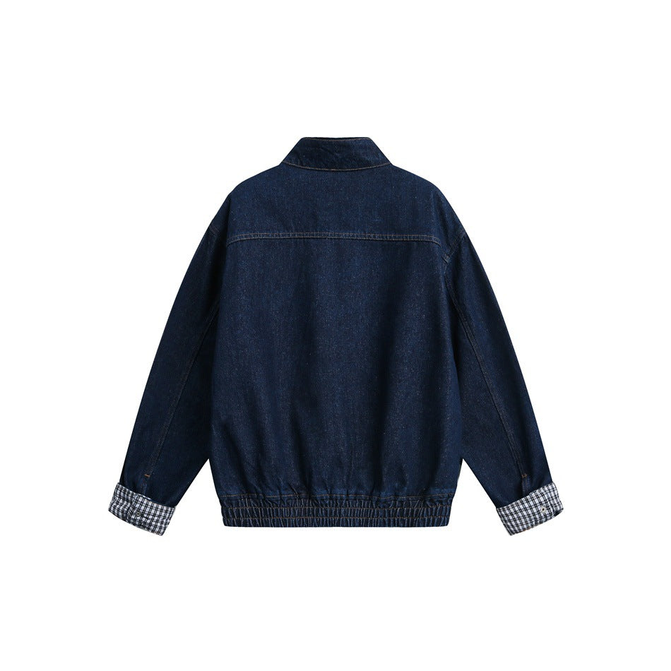 Back view of a dark indigo denim jacket with a gathered hem and black-and-white checked turned-back cuffs.