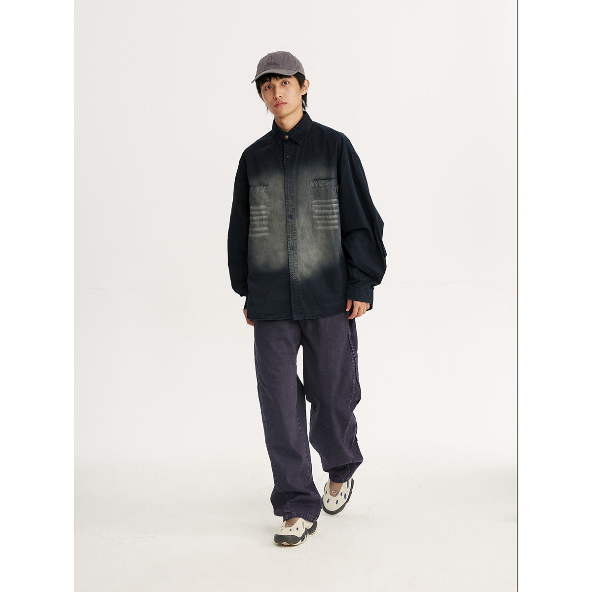 Model wearing a black button-front shirt with a charcoal faded wash and two chest pockets.