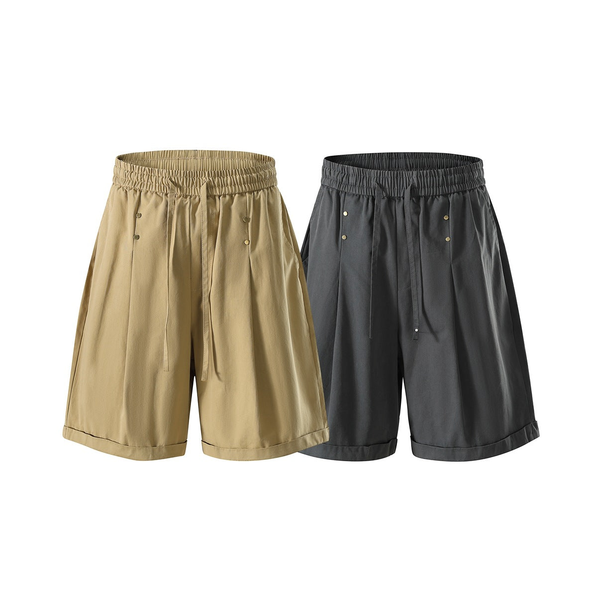 Front views of loose tan and charcoal-gray shorts with gathered waistbands, drawstrings, metal buttons and cuffed hems.