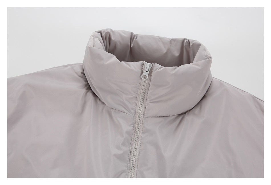 Close-up of the light gray jacket's tall padded collar and front zipper.