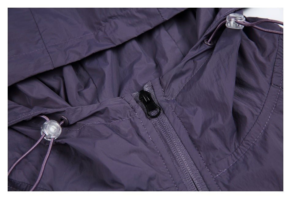 Close-up of the purple jacket’s zipper and hood drawcord with a clear plastic toggle.