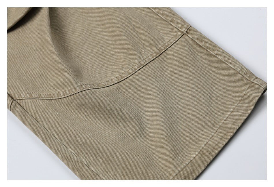 Close-up of the khaki pant leg showing a stitched panel and finished hem.