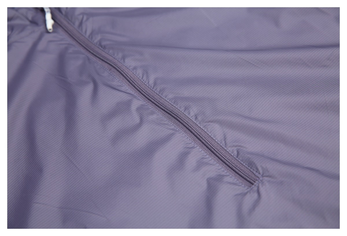 Close-up of a diagonal zipper on the fine-striped grayish lavender jacket fabric.