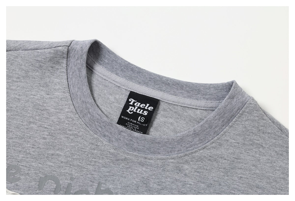 Close-up of a gray crew-neck shirt collar and black neck label.