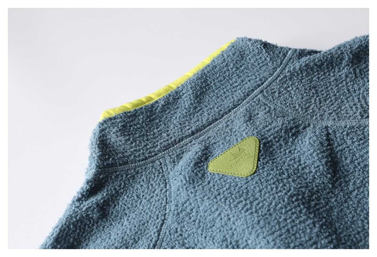 Close-up of the blue fleece jacket's upper back with a small green triangular brand patch and yellow-green trim.