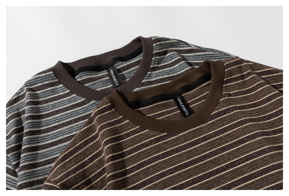 Close-up of two striped crew-neck shirts in dark brown with cream and blue-gray stripe variations.