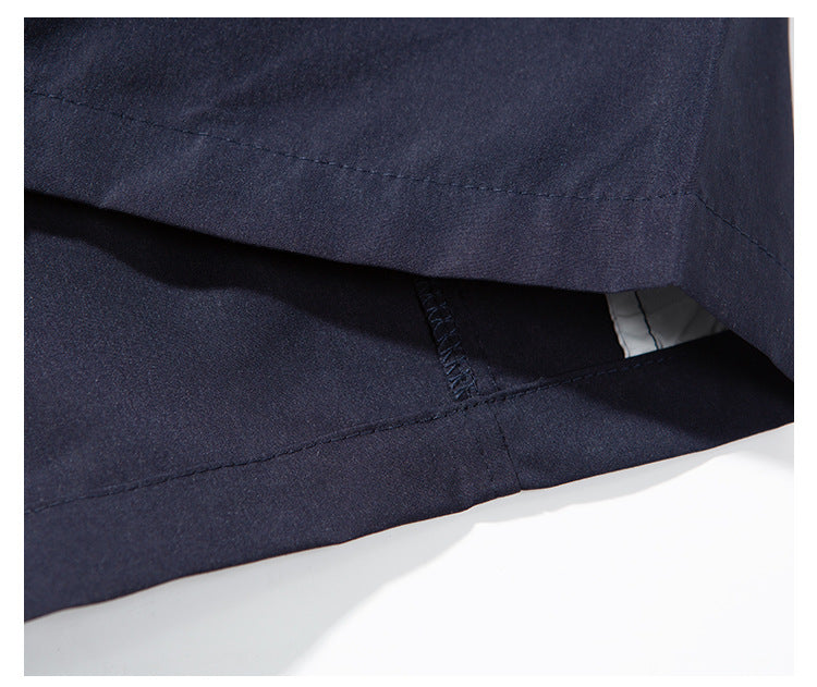 Close-up of the dark navy pants hem and interior seam construction.