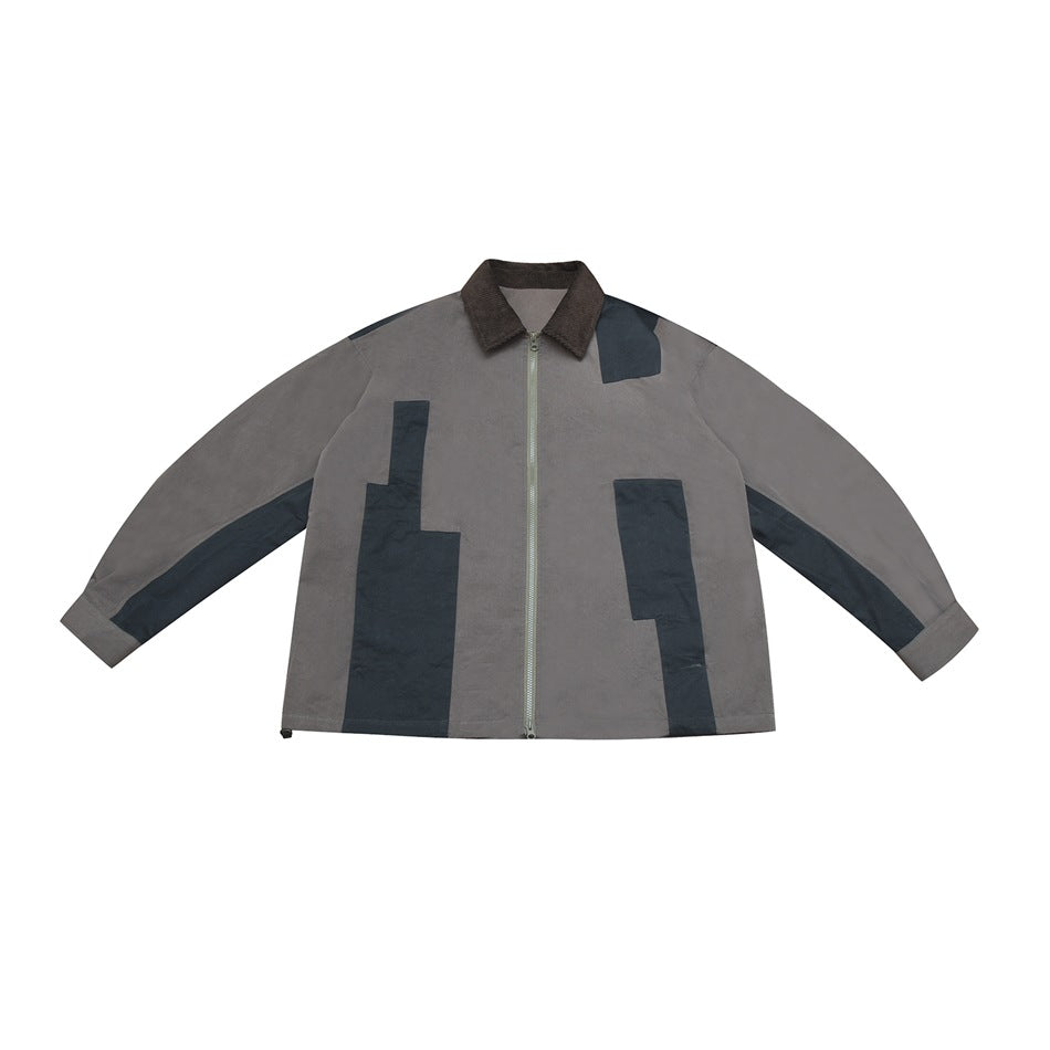 Gray zip-front jacket with brown collar and dark blue patchwork panels, flat lay front view