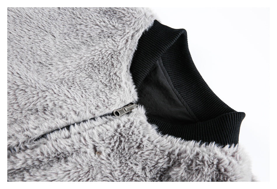 Close-up of the gray fuzzy jacket's black ribbed collar, dark lining, and metal zipper.
