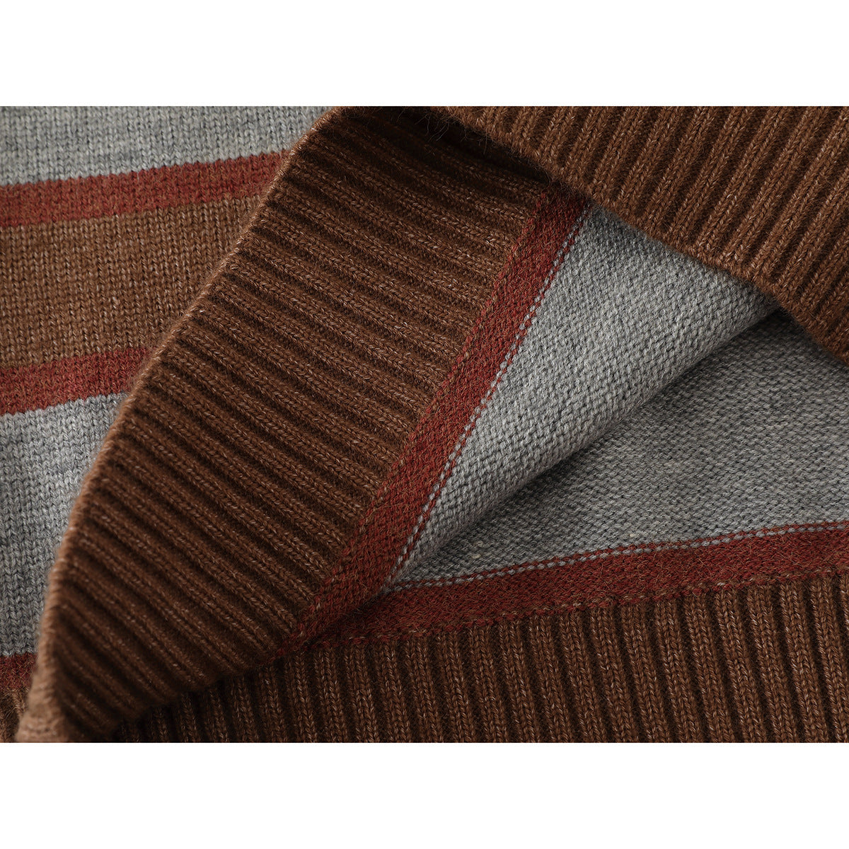 Close-up of the sweater's ribbed brown neckline and gray, rust, and brown knit stripes.